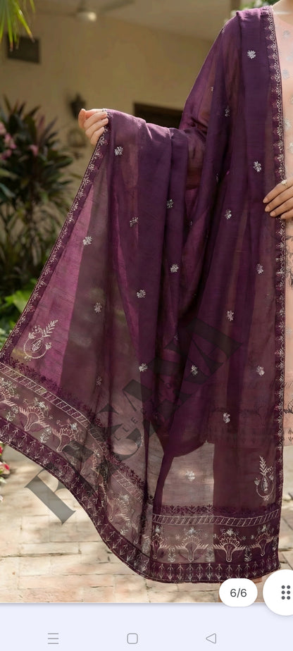 This is an unstitched lawn collection 3-piece suit with sequence embroidered front, embroidered sleeves, embroidered trouser, and a Bamber embroidered chiffon dupatta.